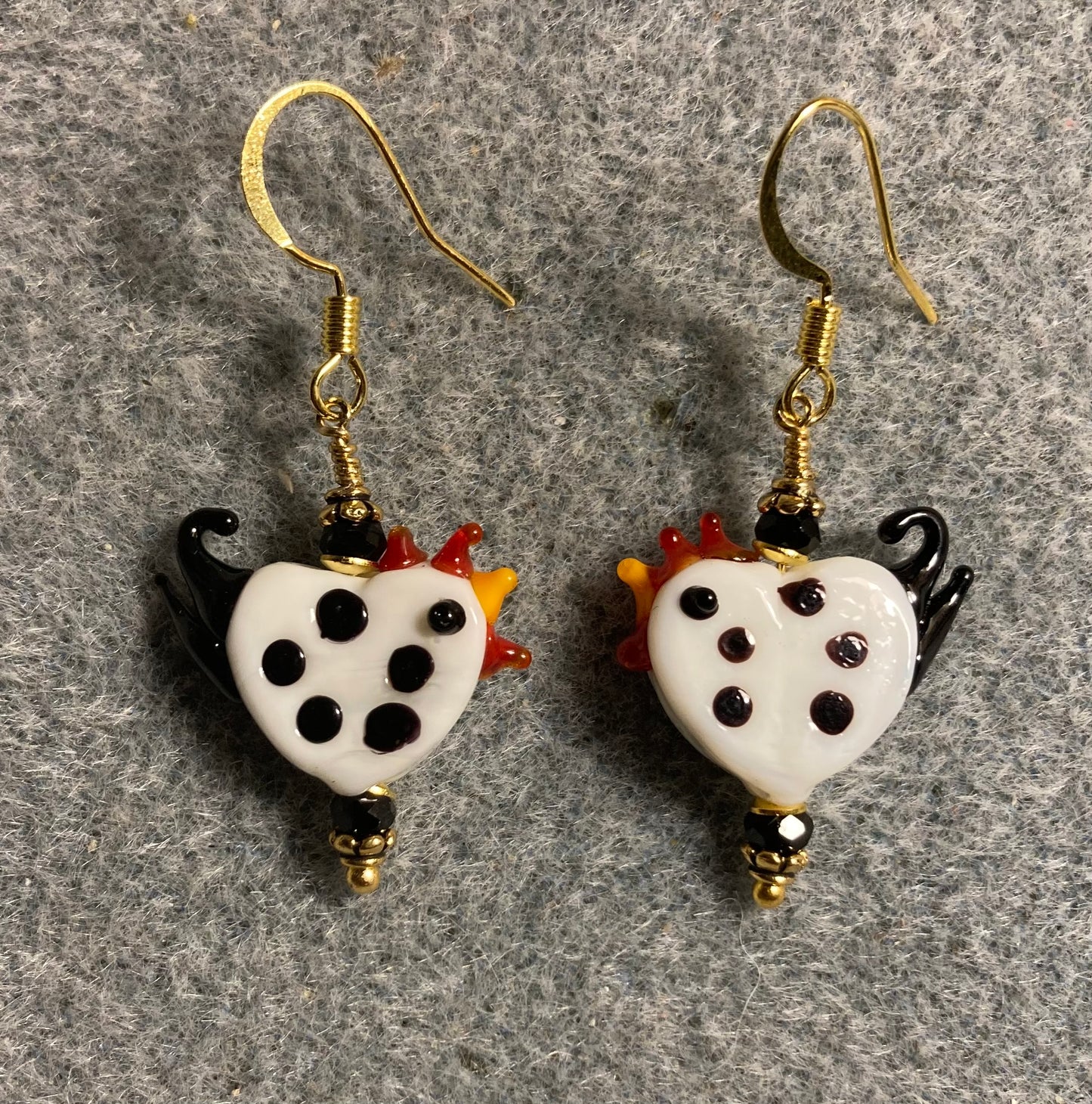 Small white with black spots lamp work rooster bead earrings adorned with black Chinese crystal beads.