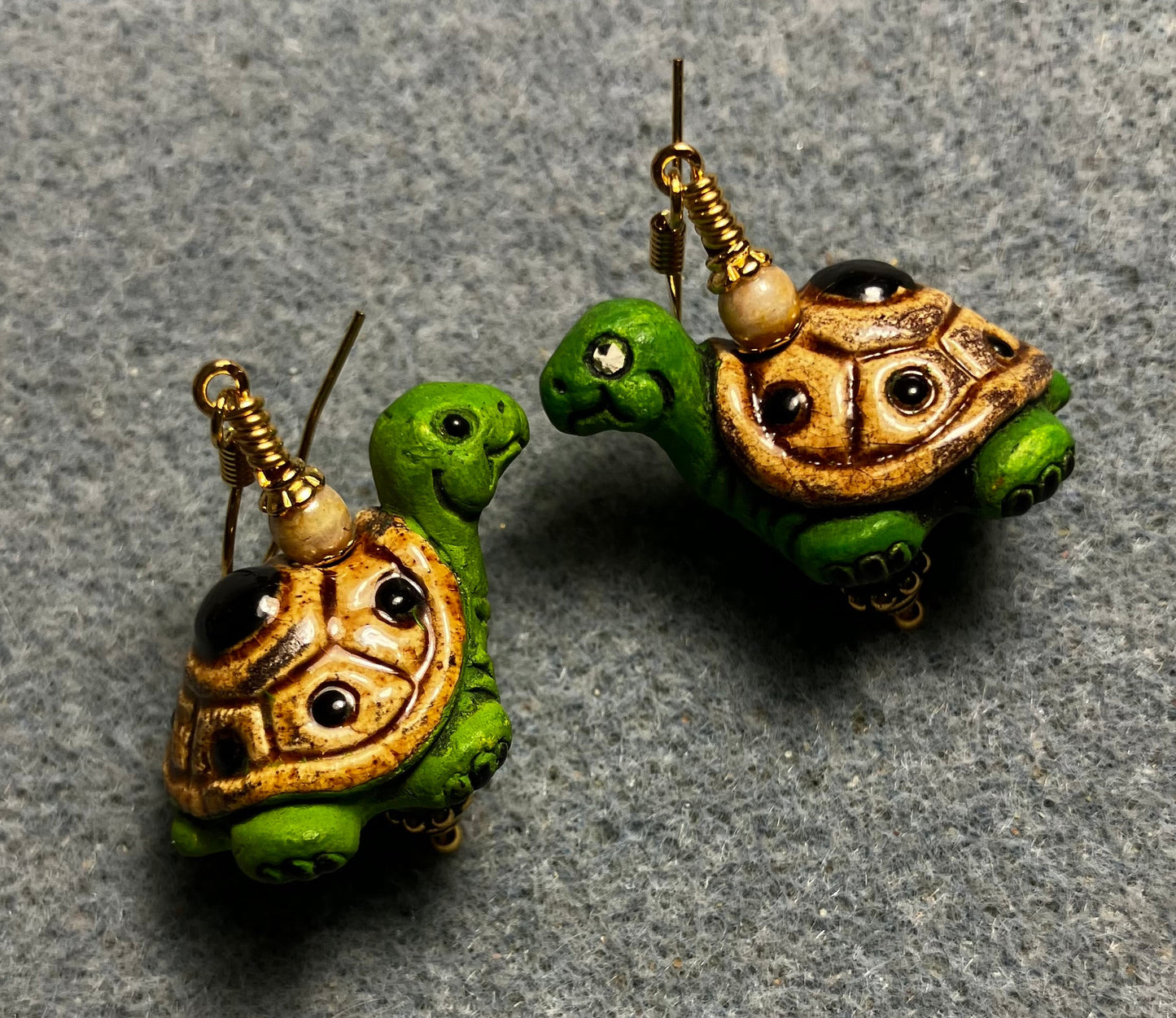 Green and tan ceramic turtle bead earrings adorned with tan Czech glass beads.