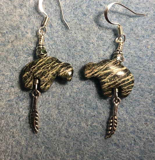 Green zebra jasper gemstone buffalo fetish bead earrings adorned with sparkly green crystal beads and tiny silver feather charms.