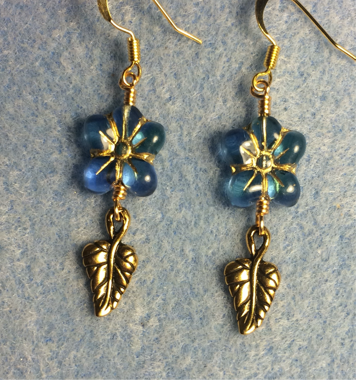 Aqua (with gold inlay) Czech glass puffy flower bead earrings adorned with gold Tierracast leaf charms.