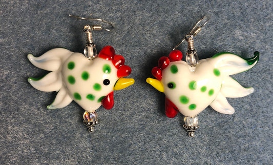 White with green spots heart shaped lamp work rooster bead earrings adorned with clear Czech glass beads.