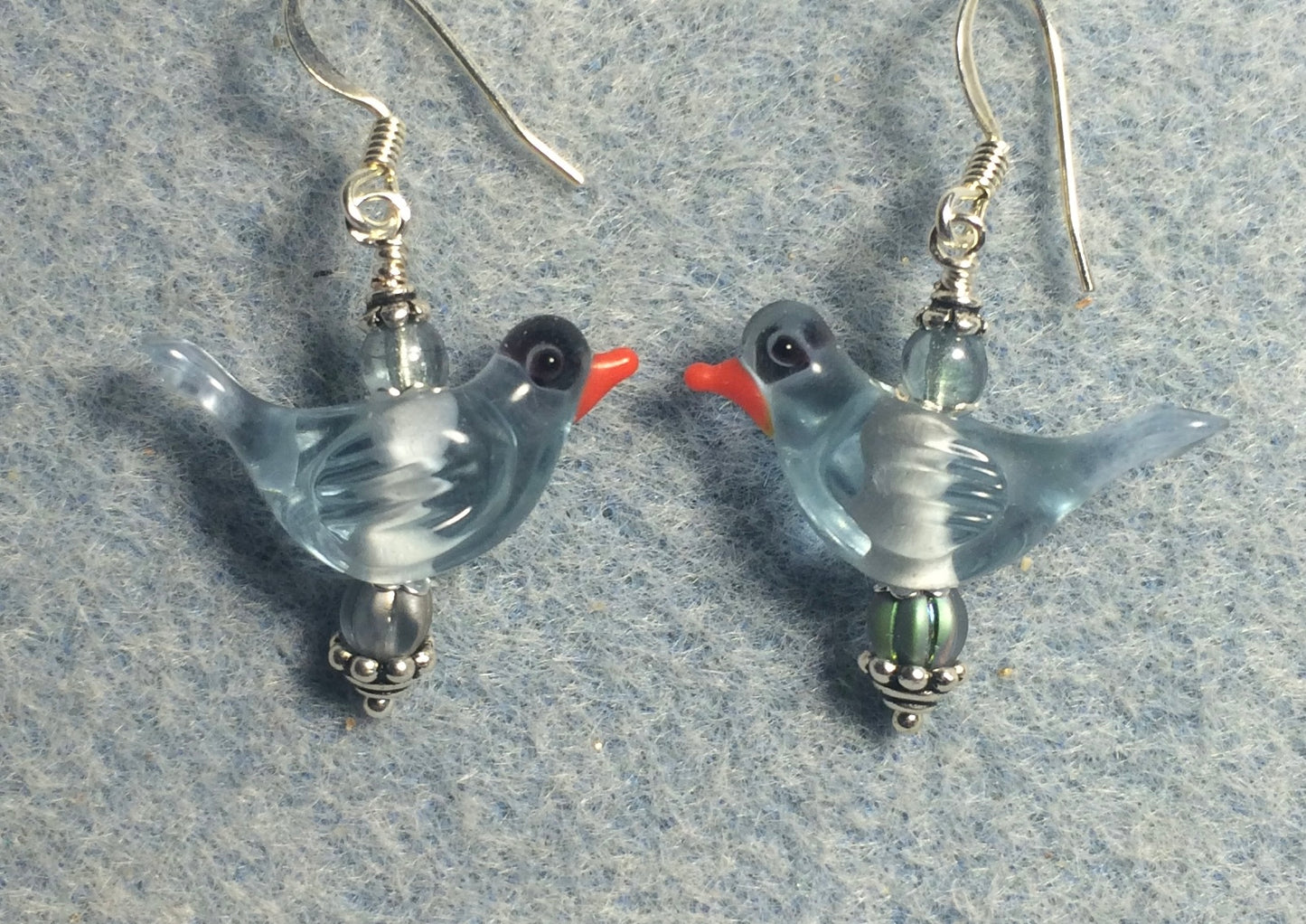 Translucent light blue lamp work songbird bead earrings adorned with light blue Czech glass beads.