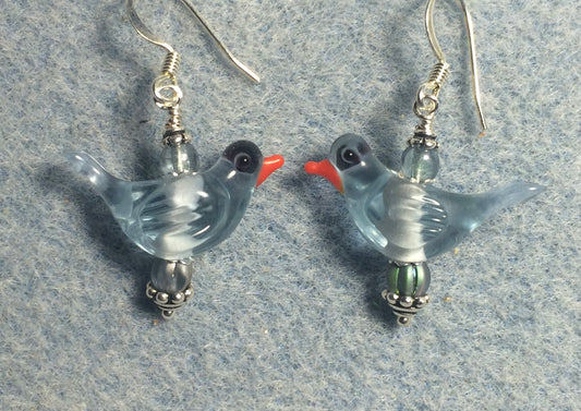 Translucent light blue lamp work songbird bead earrings adorned with light blue Czech glass beads.