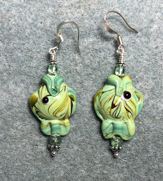 Green lamp work fish bead earrings adorned with green Czech glass beads.