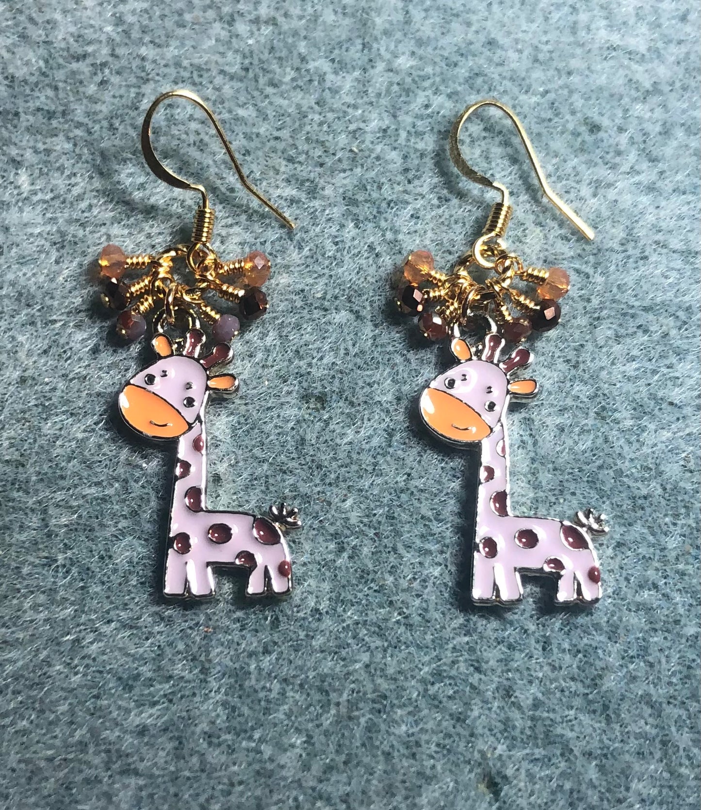 Violet, orange, and brown enamel spotted giraffe charm earrings adorned with tiny dangling violet, orange, and brown Chinese crystal beads.