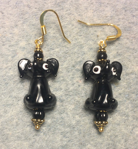 Opaque black lamp work sitting elephant bead earrings adorned with black Czech glass beads.