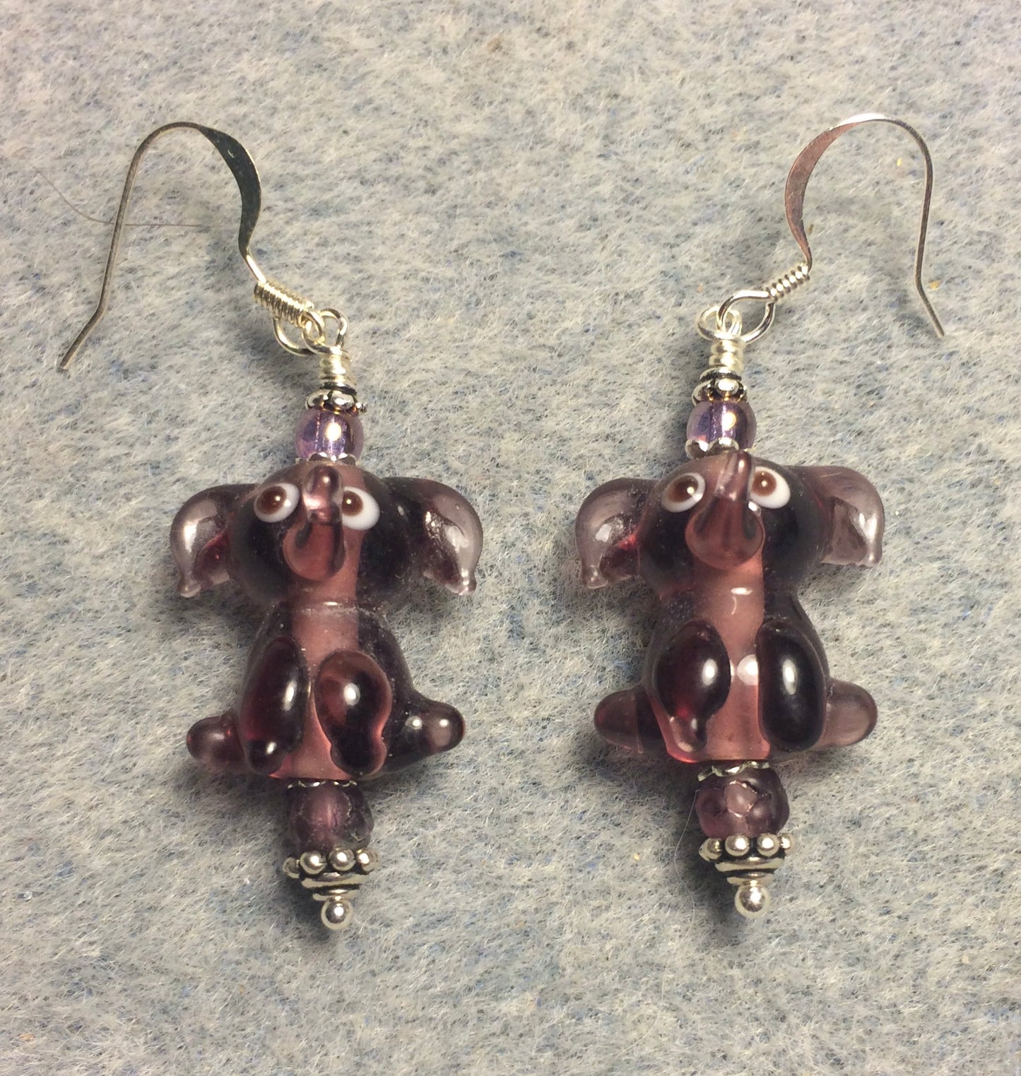Translucent violet lamp work sitting elephant bead earrings adorned with violet Czech glass beads.