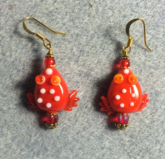 Opaque red lamp work frog bead earrings adorned with red Czech glass beads.