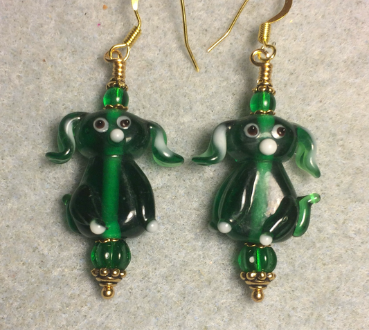 Translucent emerald green lamp work floppy eared puppy dog bead earrings adorned with emerald green Czech glass beads.