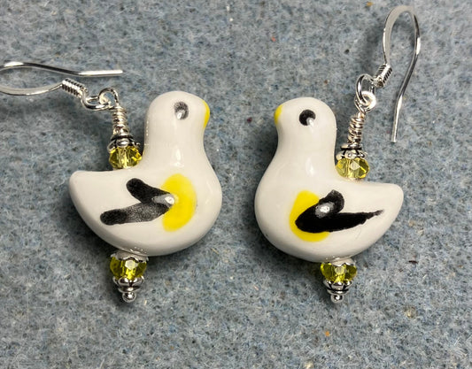 White, black, and yellow ceramic duck bead earrings adorned with yellow Chinese crystal beads.