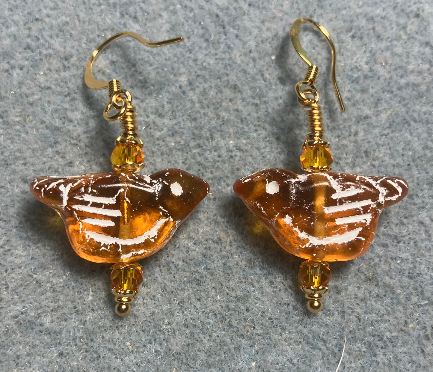 Amber (with white inlay) Czech glass bird bead earrings adorned with amber Chinese crystal beads.