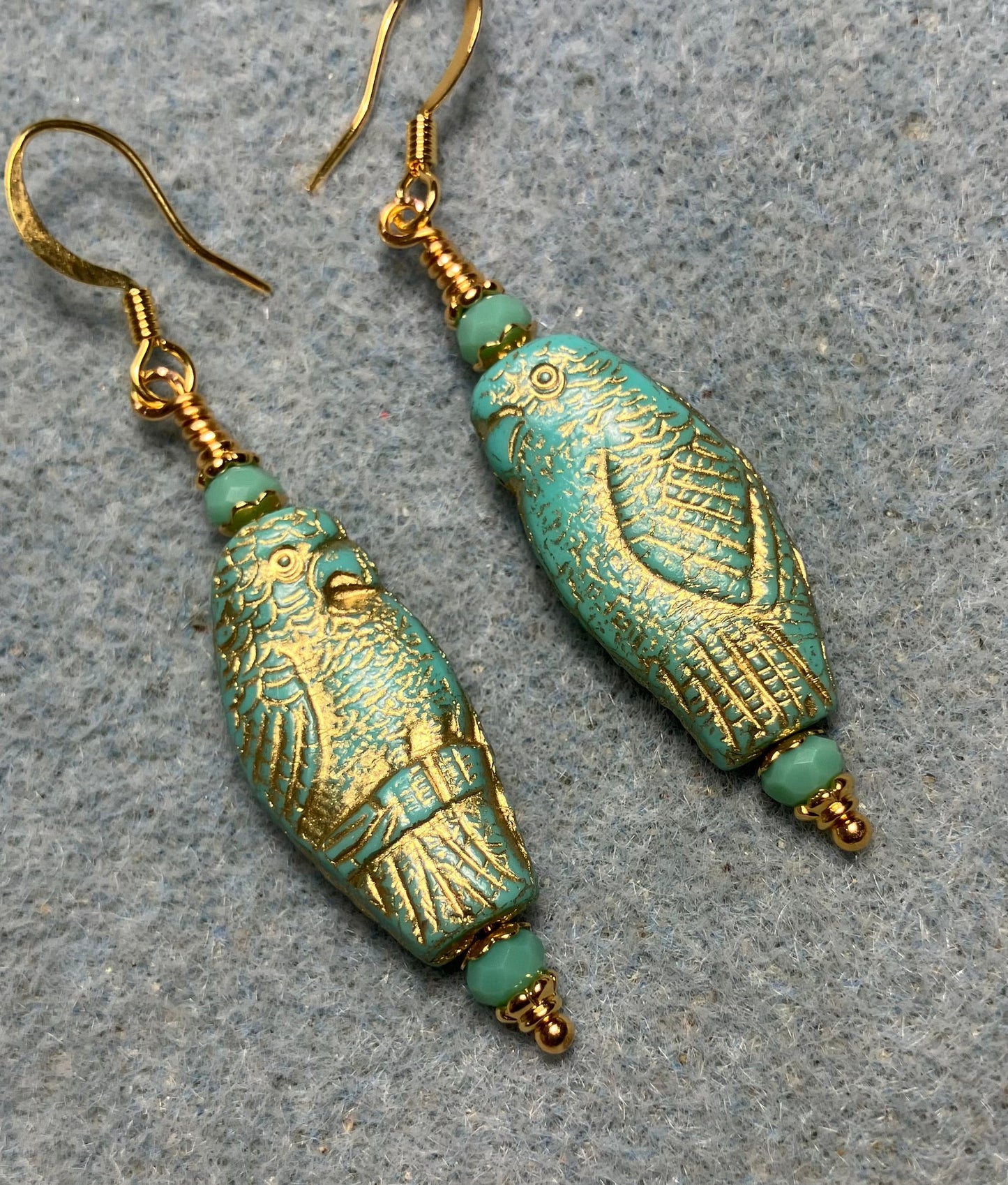 Large turquoise (with gold wash) Czech glass parrot bead earrings adorned with turquoise Chinese crystal beads.