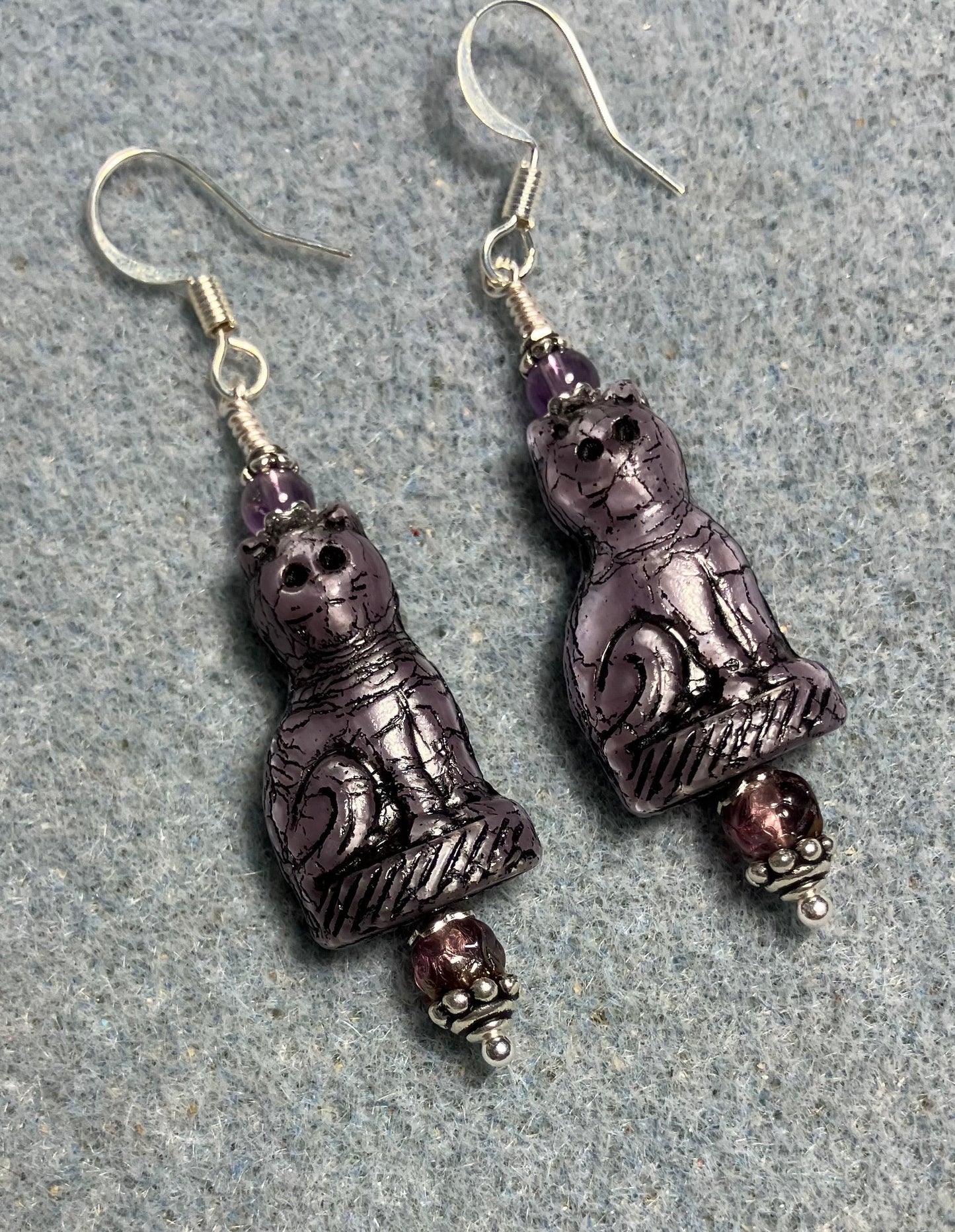 Opaque purple (with black inlay) fancy Czech glass fancy cat bead earrings adorned with purple Czech glass beads.
