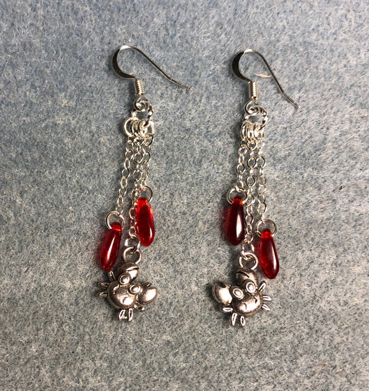 Small silver crab charm earrings attached to silver chain and adorned with small red Czech glass dagger beads