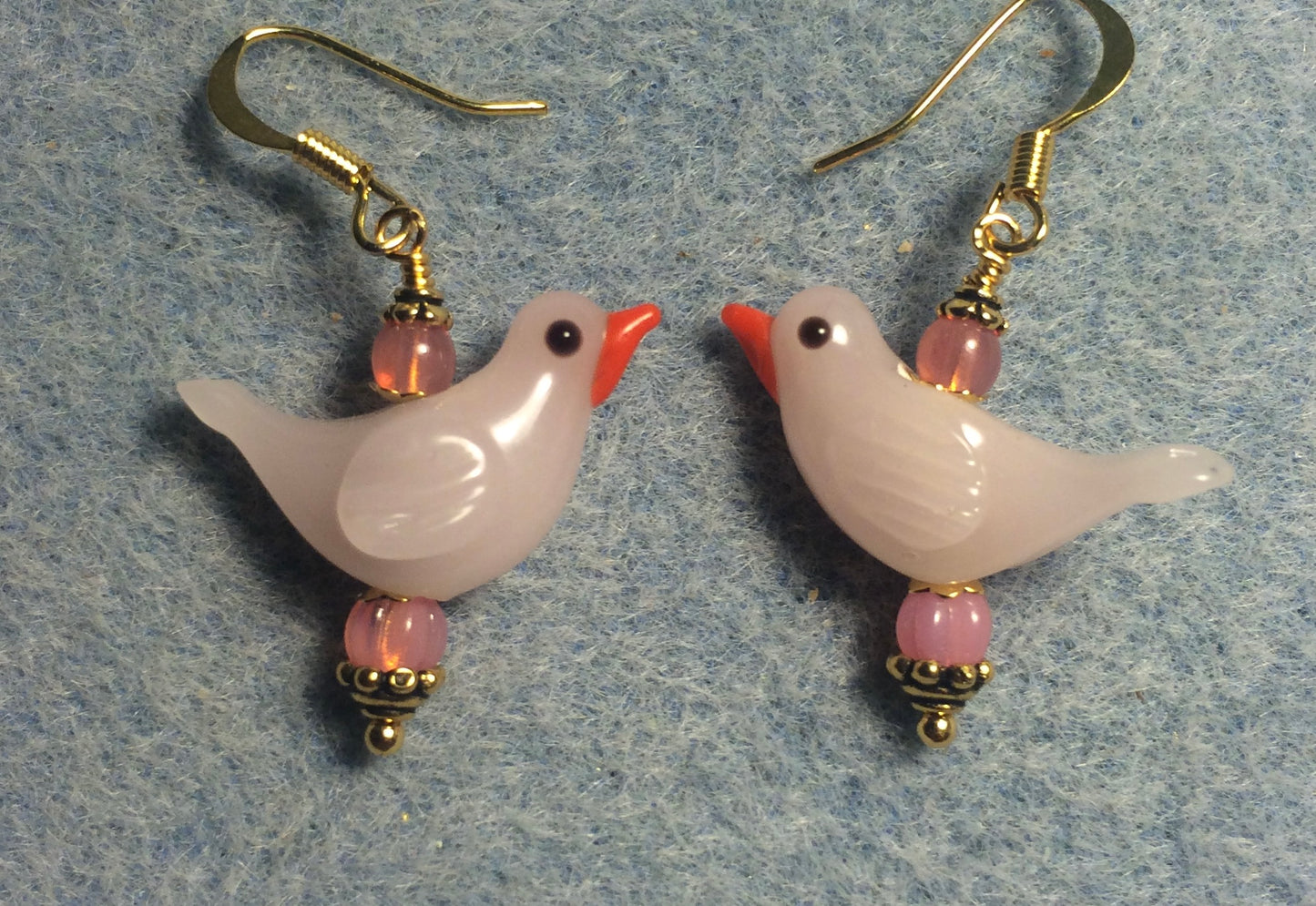 Milky pink lamp work songbird bead earrings adorned with pink Czech glass beads.