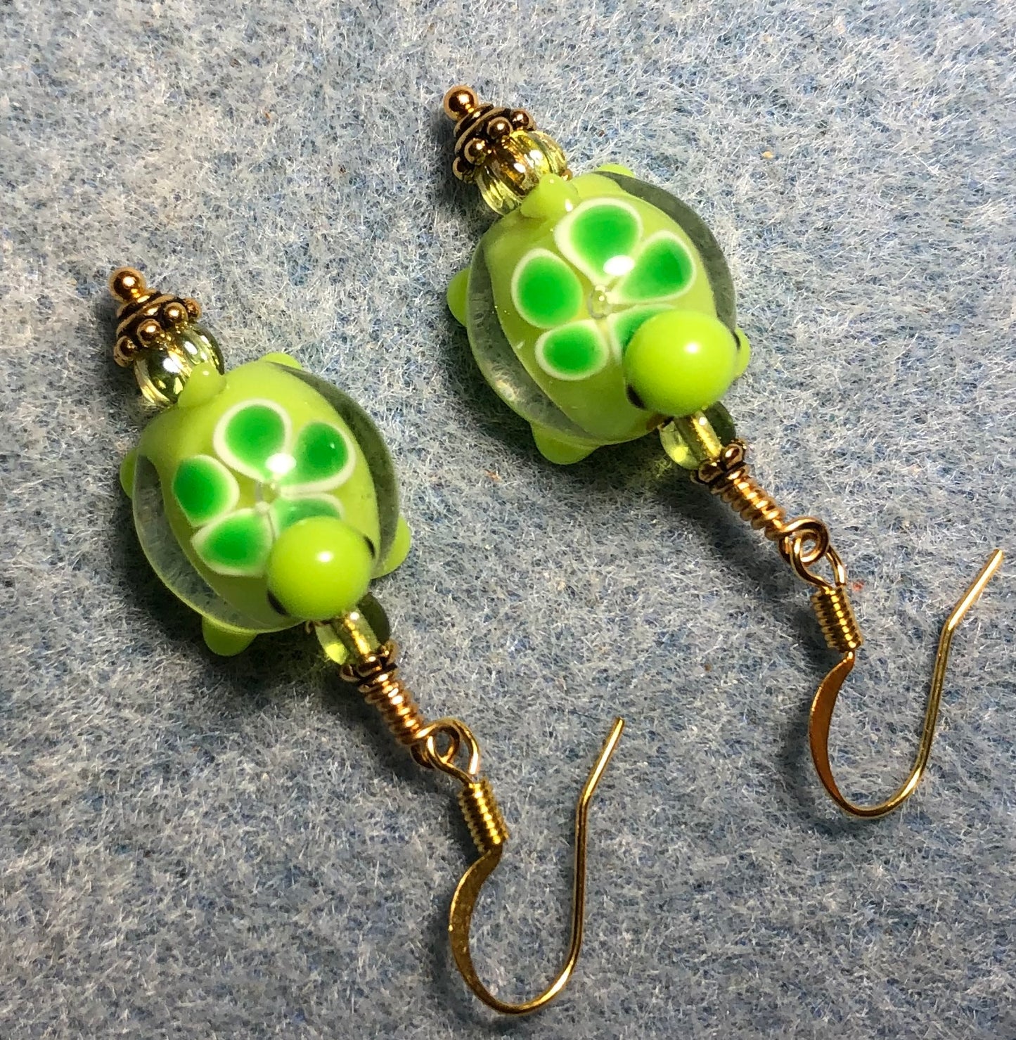 Small lime green lamp work turtle bead earrings adorned with lime green Czech glass beads.