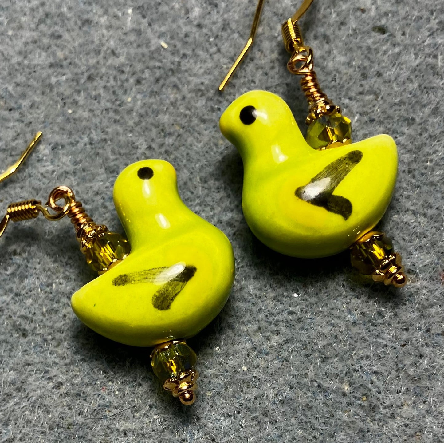 Lime green, black, and yellow ceramic duck bead earrings adorned with lime green Chinese crystal beads.