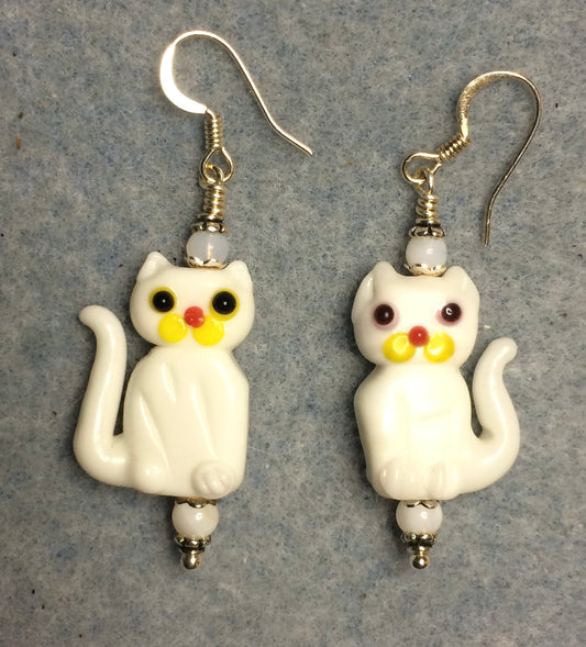 Opaque white lamp work cat bead earrings adorned with white Czech glass beads.