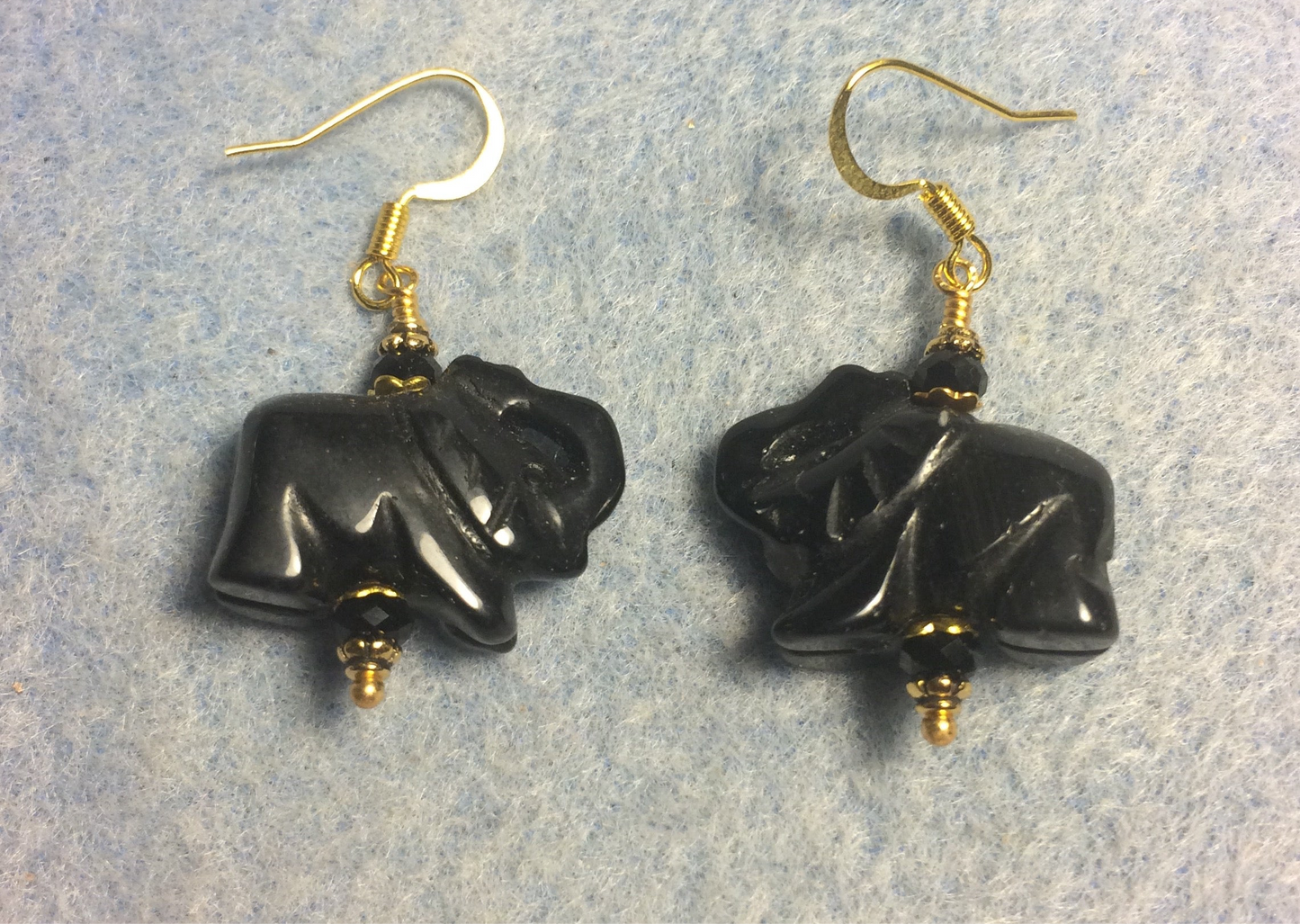 Black onyx agate gemstone elephant bead earrings adorned with black Chinese crystal beads.