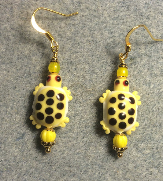 Yellow and white lamp work spotted turtle bead earrings adorned with yellow Czech glass beads.