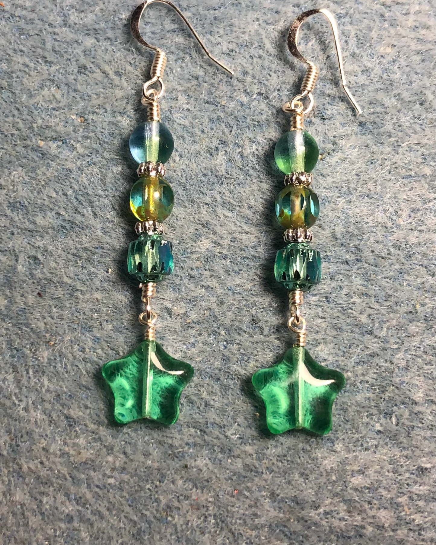 Small translucent light green Czech glass star bead earrings adorned with light green Czech glass beads.