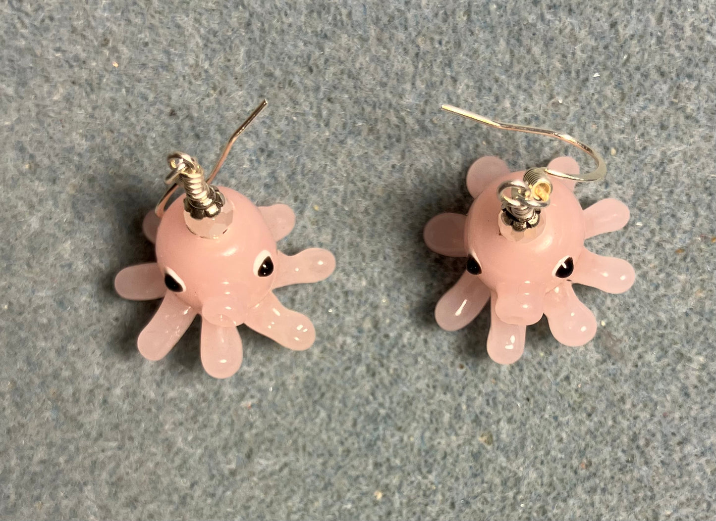 Pink lamp work octopus bead earrings adorned with pink Chinese crystal beads.
