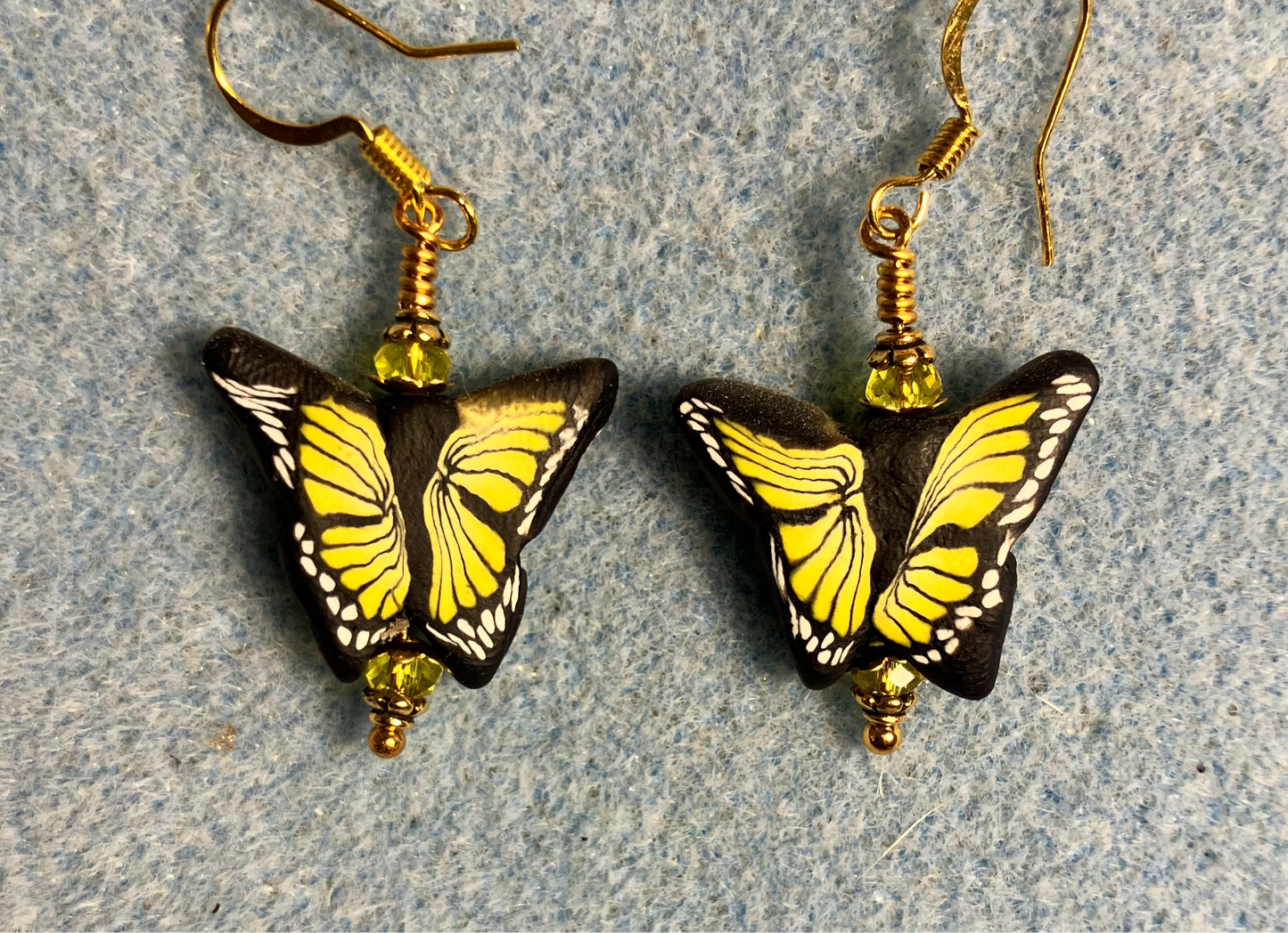 Yellow and black polymer clay butterfly bead earrings adorned with yellow Chinese crystal beads.