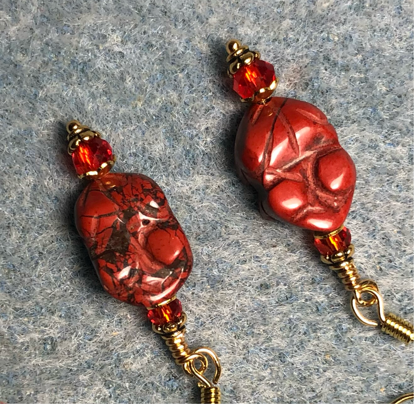 Small red brecciated jasper gemstone frog bead earrings adorned with red Chinese crystal beads.