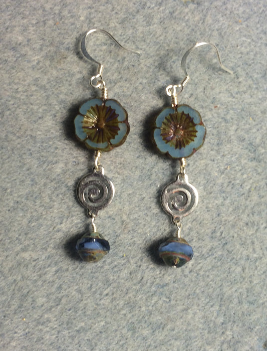 Light blue Czech glass pansy bead earrings adorned with silver swirly connectors and light blue Czech glass Saturn beads.