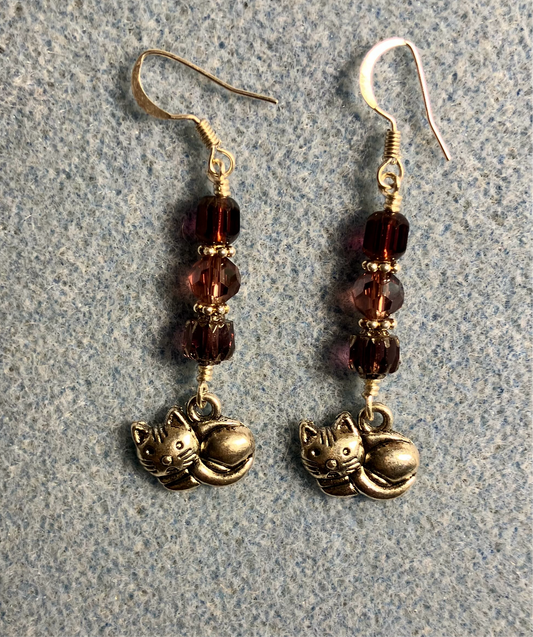 Silver sleeping cat charm earrings adorned with purple Czech glass beads.