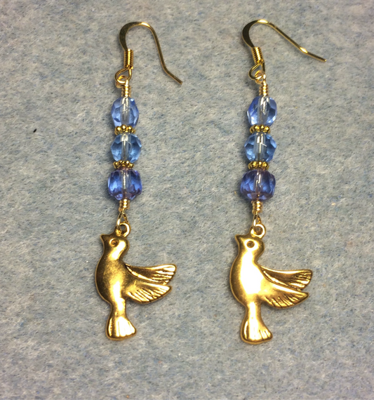 Gold flying dove charm earrings adorned with light blue Czech glass beads