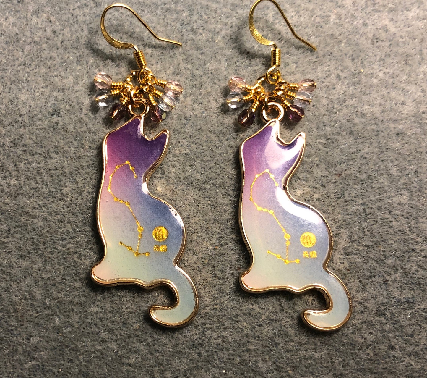 Violet, blue, and pink enamel cat charm earrings adorned with tiny dangling violet, blue, and pink Czech glass beads.