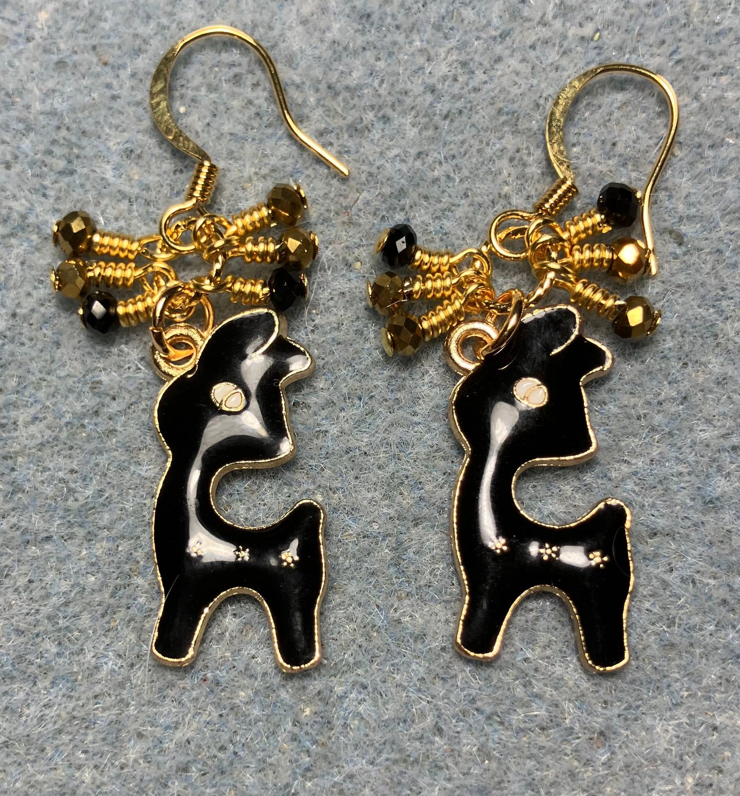 Black enamel deer charm earrings adorned with tiny dangling black and gold Chinese crystal beads.