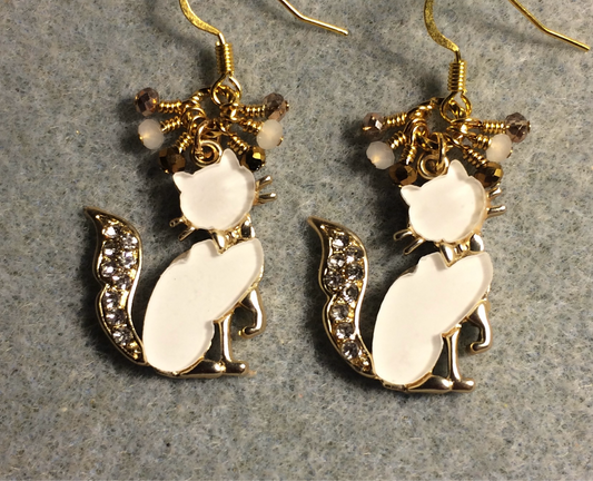Gold and white resin and rhinestone cat charm earrings adorned with tiny dangling white and gold Chinese crystal beads.