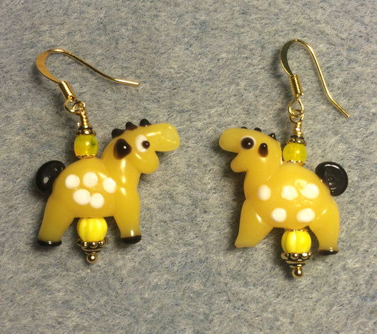 Opaque yellow lamp work spotted horse bead earrings adorned with yellow Czech glass beads.