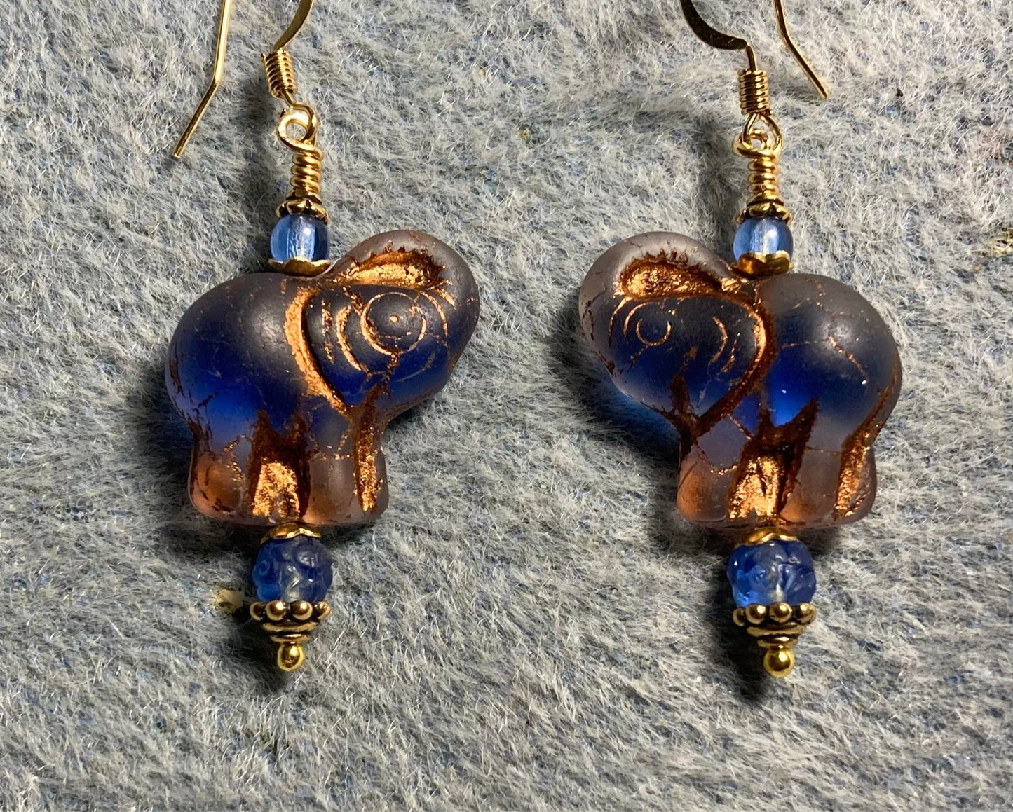 Translucent blue (with copper inlay) Czech glass elephant bead earrings adorned with blue Czech glass beads.