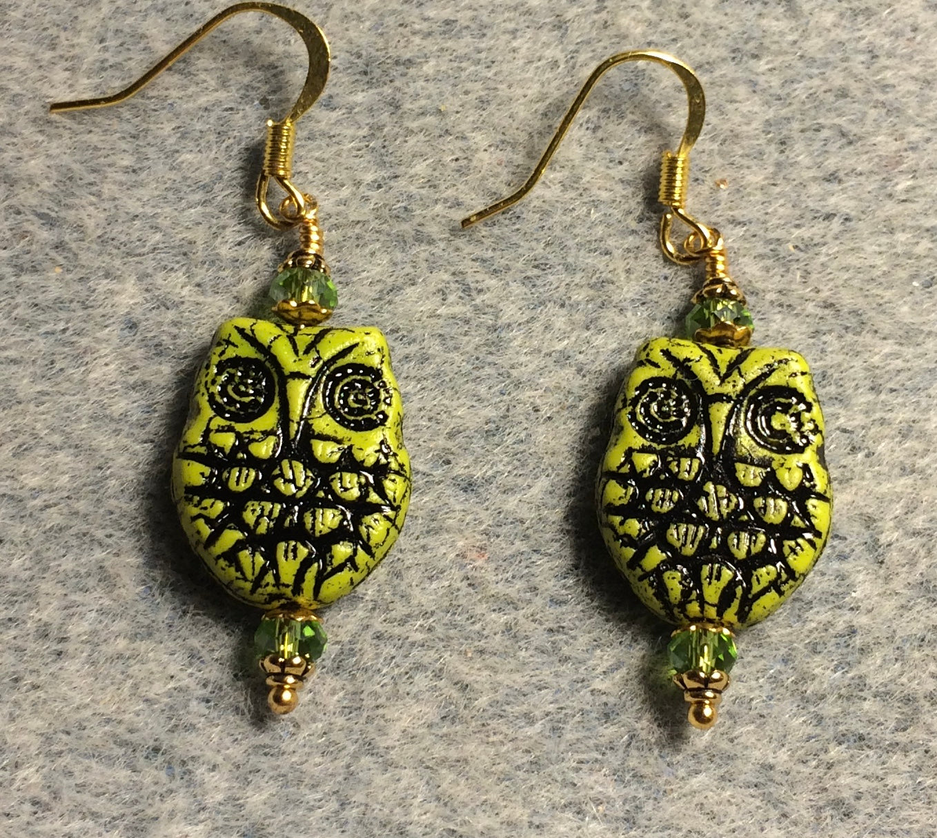 Lime green (with black wash) Czech glass owl bead earrings adorned with lime green Chinese crystal beads.