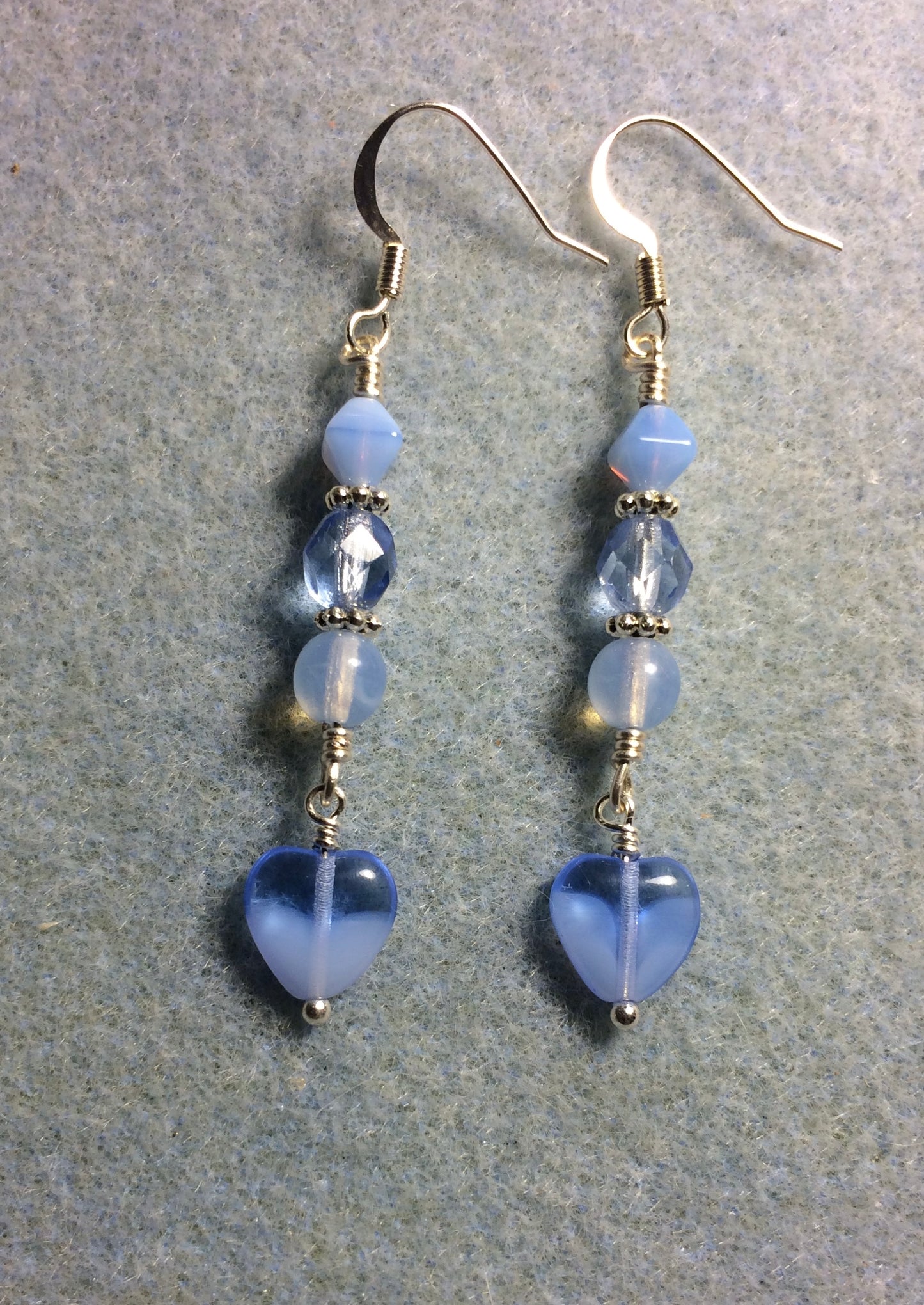 Small light milky blue Czech glass heart bead earrings adorned with light blue Czech glass beads.