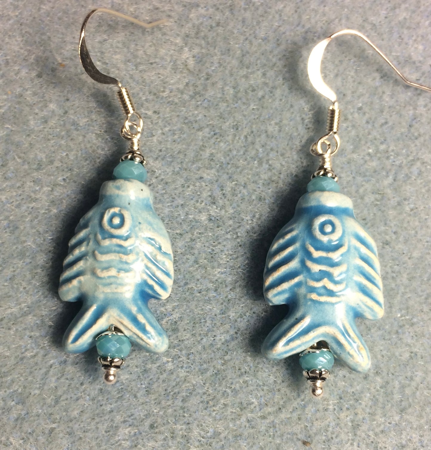 Light blue ceramic fish bead earrings adorned with light blue Chinese crystal beads.