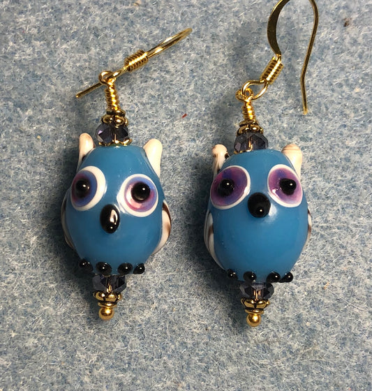 Blue and violet lamp work owl bead earrings adorned with violet Chinese crystal beads.