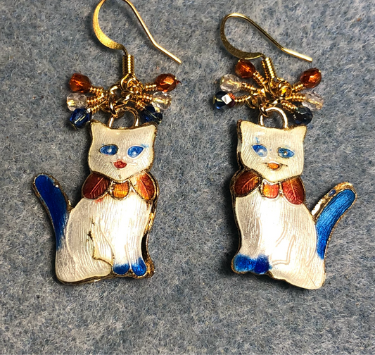 White, light blue, and orange cloisonné cat charm earrings adorned with small dangling clear, light blue, and orange Czech glass beads.