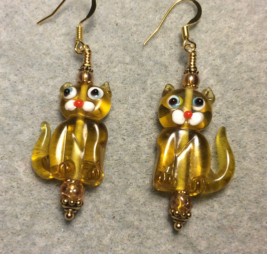 Translucent light amber lamp work cat bead earrings adorned with amber Czech glass beads.