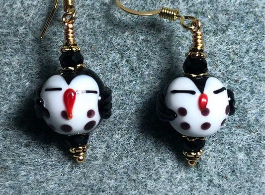 Small black and white lamp work sleepy owl bead earrings adorned with black Chinese crystal beads.