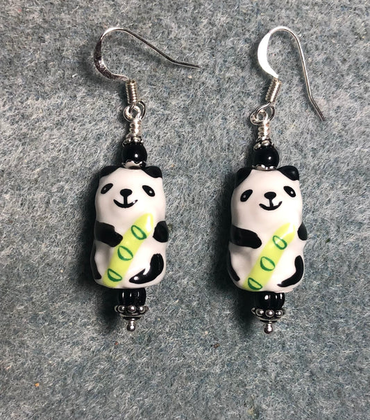 Black, white, and green ceramic panda bear bead earrings adorned with black Czech glass beads.