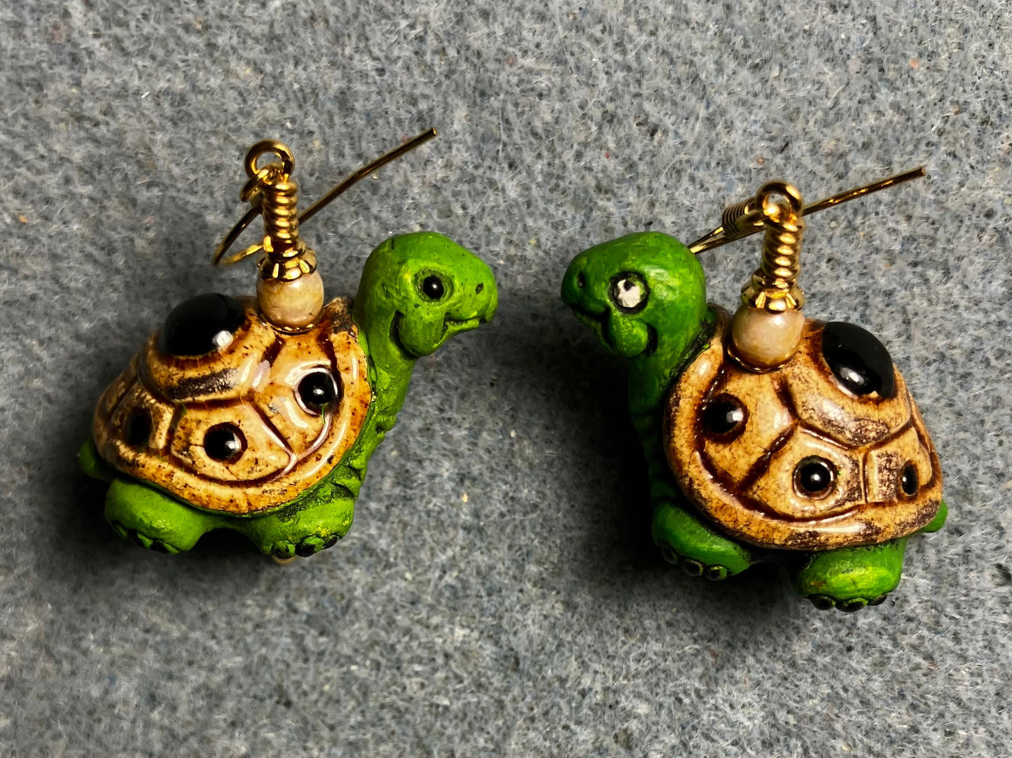 Green and tan ceramic turtle bead earrings adorned with tan Czech glass beads.
