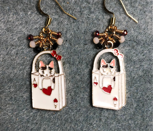 White, pink, and red enamel cat charm earrings adorned with tiny dangling white, red, and black Chinese crystal beads.