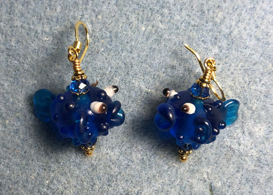 Translucent bright blue lamp work fish bead earrings adorned with bright blue Chinese crystal beads.