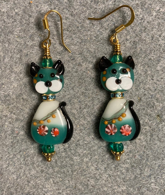 Teal and black lamp work striped two piece cat bead earrings adorned with teal rhinestone “collars” and teal Czech glass beads.