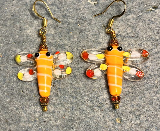Tangerine, red, and yellow lamp work dragonfly bead earrings adorned with tangerine Chinese crystal beads.