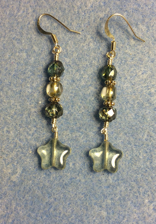 Small translucent light green Czech glass star bead earrings adorned with light green Czech glass beads.